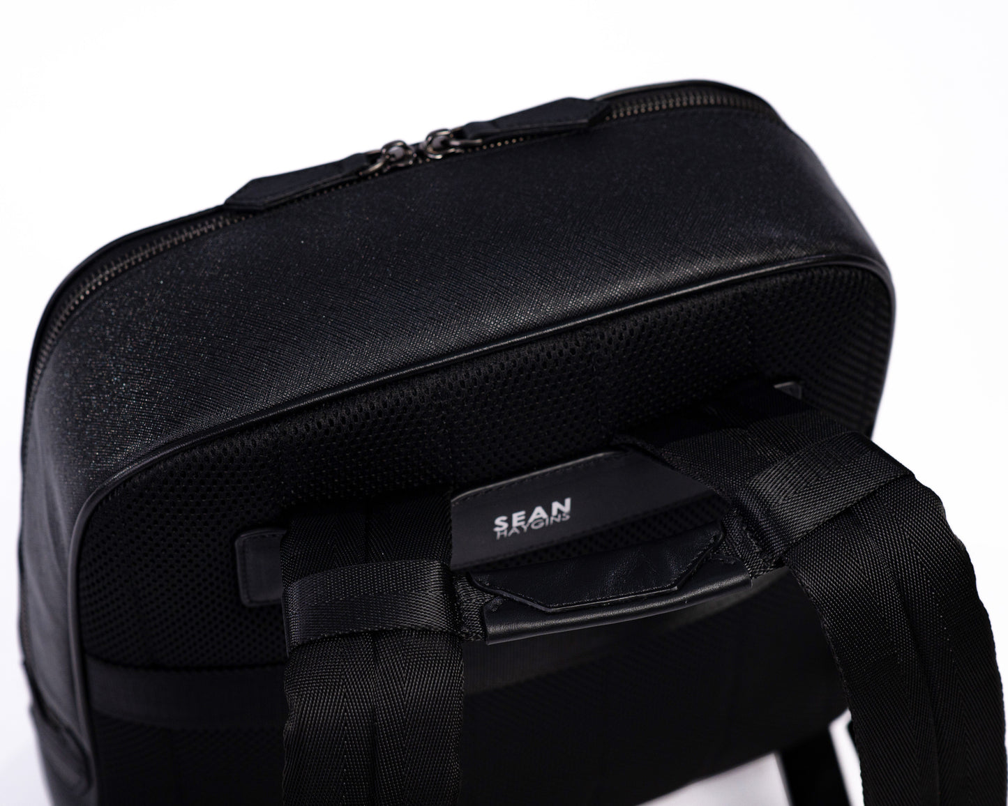 Black backpack with visible brand name on a white background