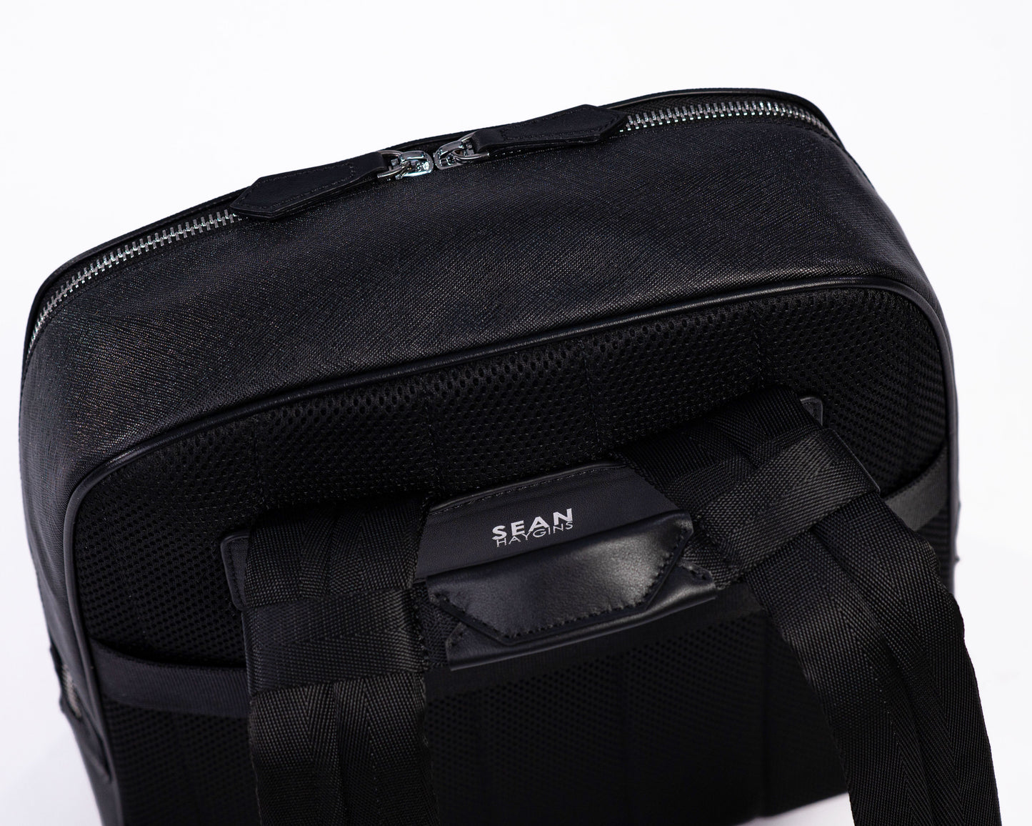 Black backpack with visible brand name on a white background
