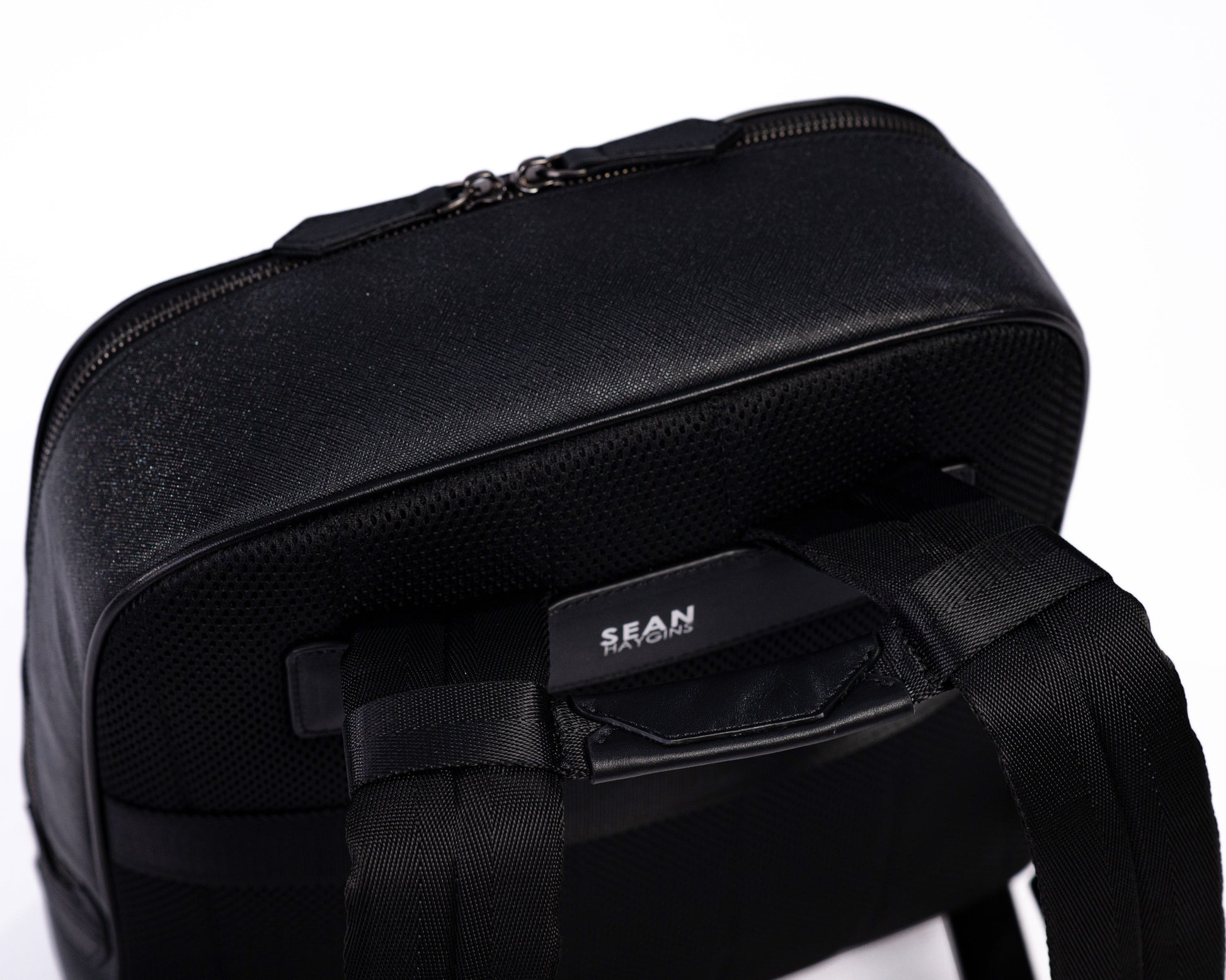 Black backpack with visible brand name on a white background