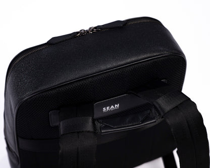 Black backpack with visible brand name on a white background