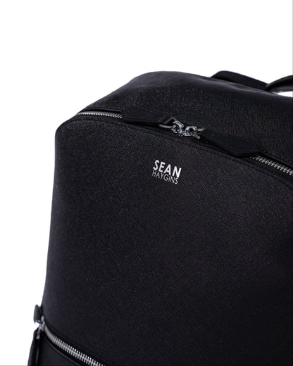 Black backpack with 'Sean Kington' branding on a white background