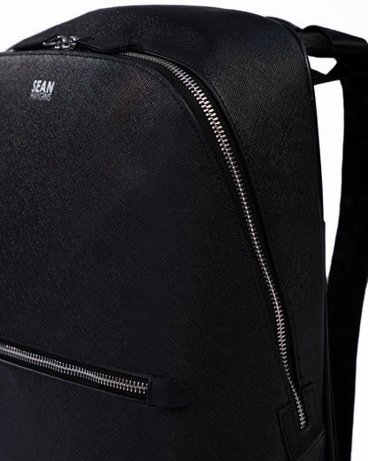Black backpack with a visible brand logo on a white background
