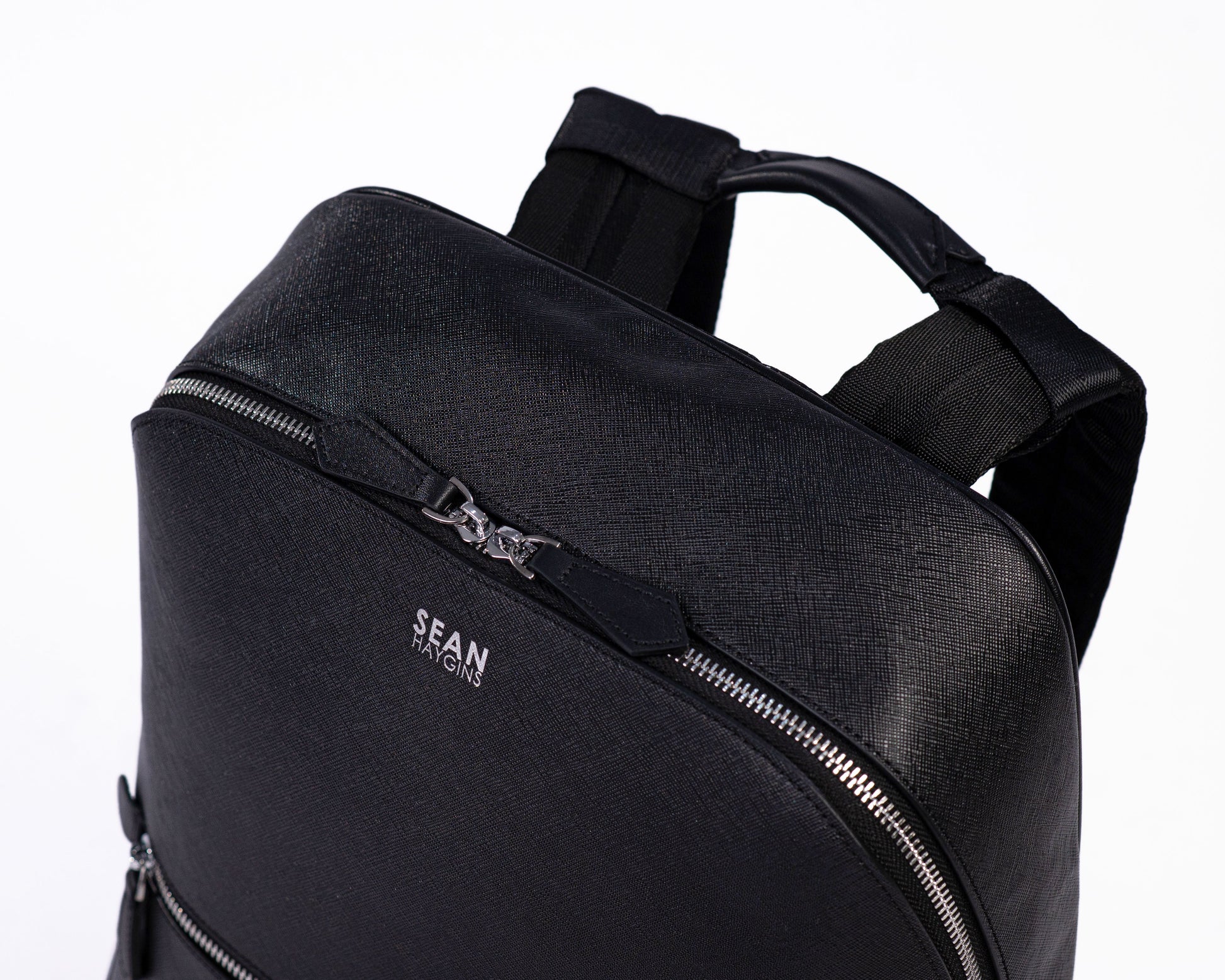 Black backpack with 'SEAN' branding on a white background