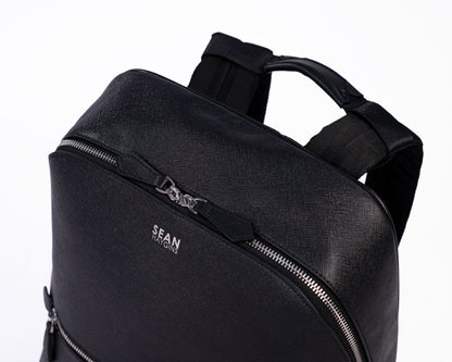 Black backpack with 'SEAN' branding on a white background