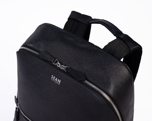 Black backpack with 'SEAN' branding on a white background
