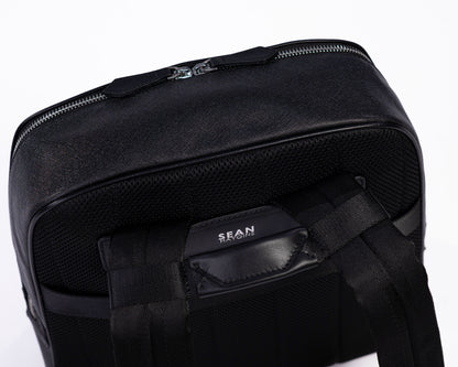 Black backpack with visible brand name on a white background