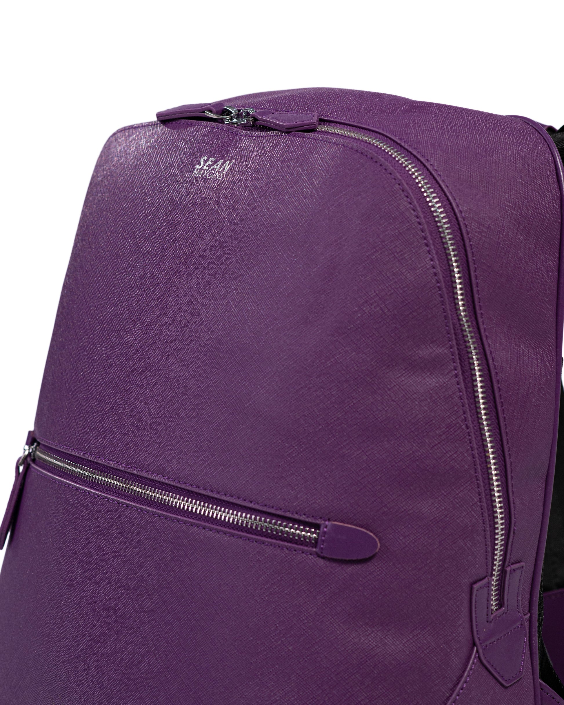 Purple backpack with zippers on a white background