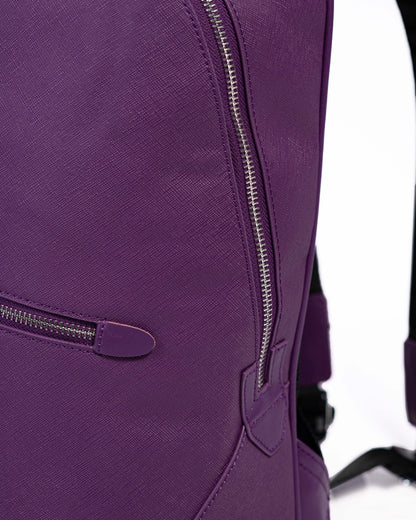 Close-up of a purple backpack with zippers on a white background