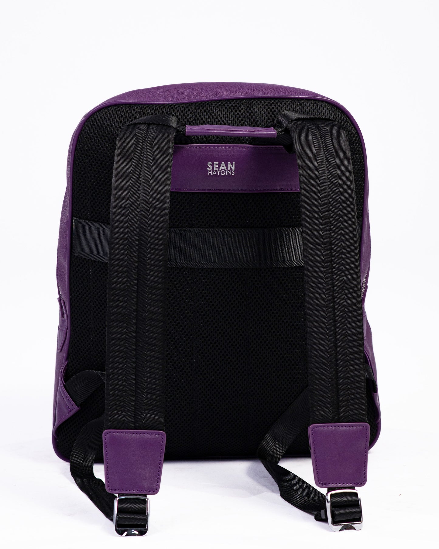 Purple backpack with visible brand logo on a white background