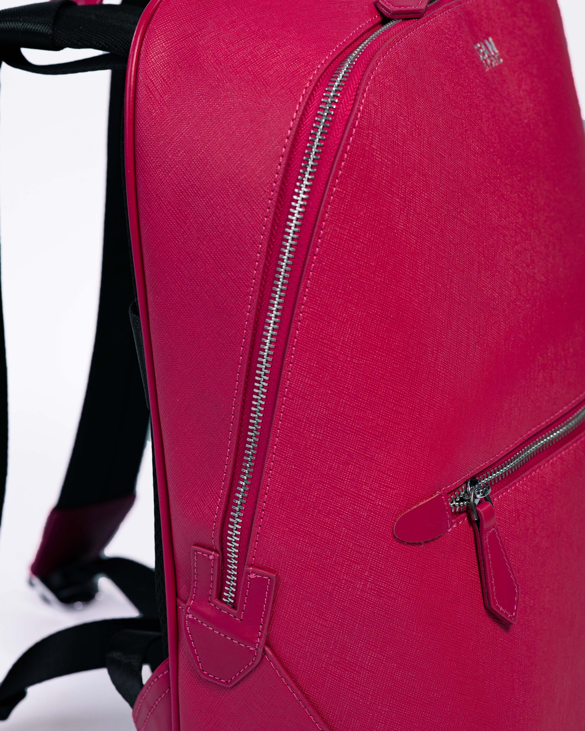 Pink backpack with zippers on a white background