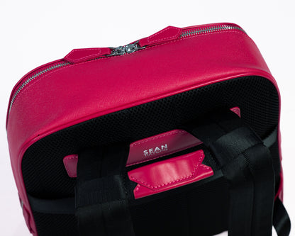 Pink backpack with a visible brand name on a white background