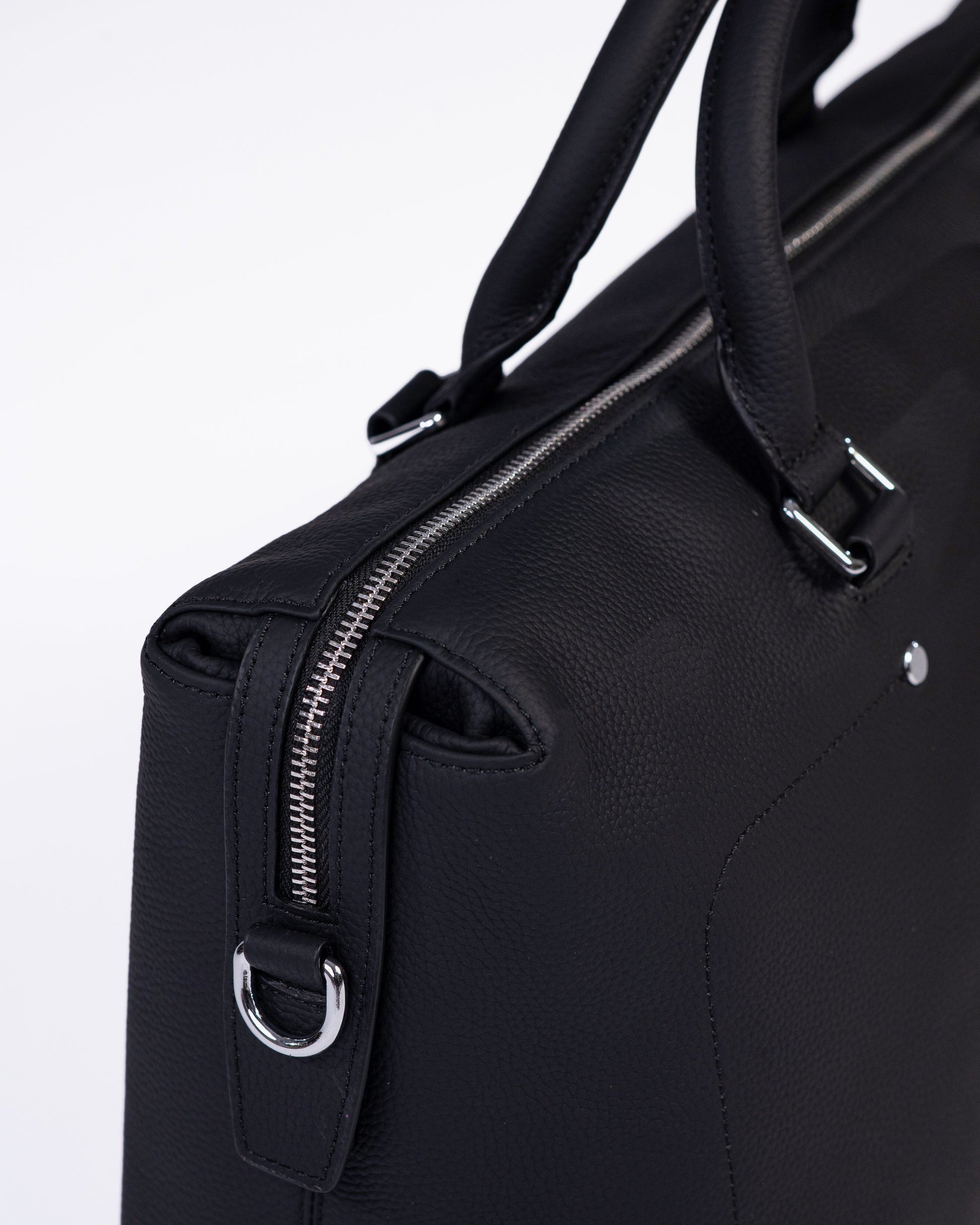 Black briefcase with silver zippers on a light gray background