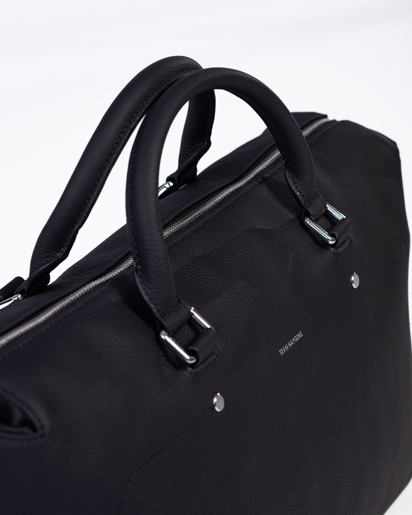 Black briefcase with handle on a white background