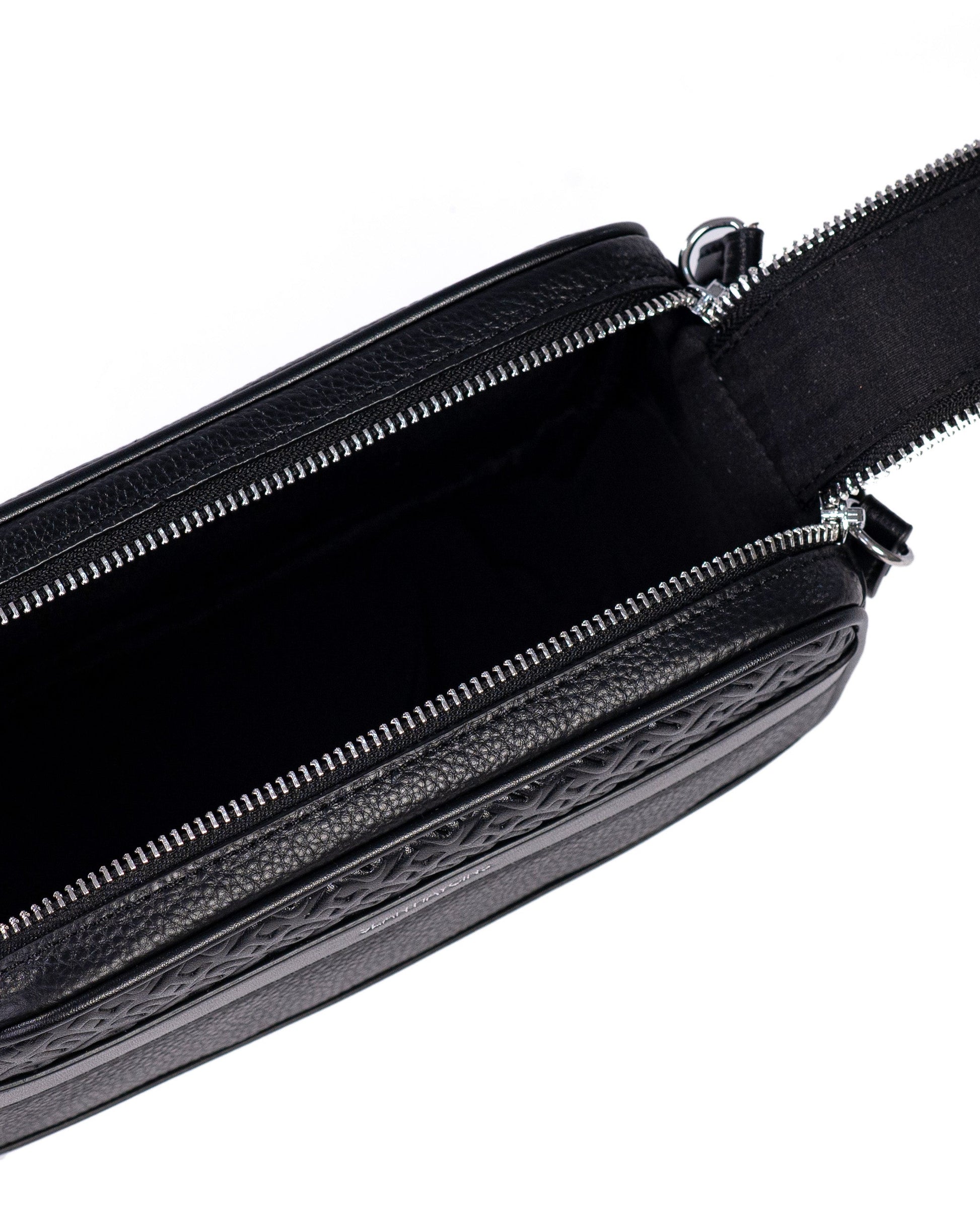 Black leather bag with a strap on a white background